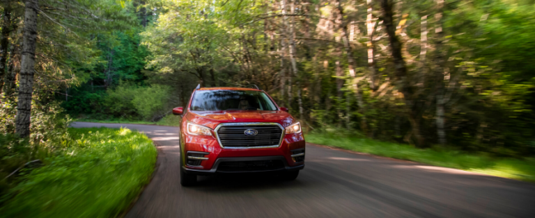 2020 Subaru Ascent SUV driving down tree lined road